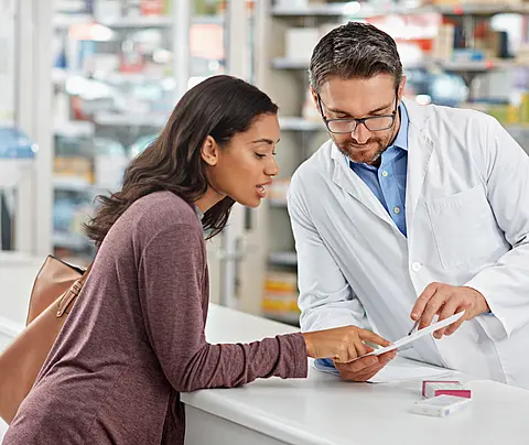 Pharmacist consults customer