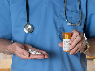 Doctor holding pills