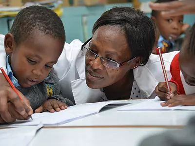 A teacher works with a child in the Tayari early education program in Kenya.