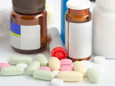 Pills in front of medicine bottles