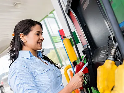 Woman pays for gas at pumps