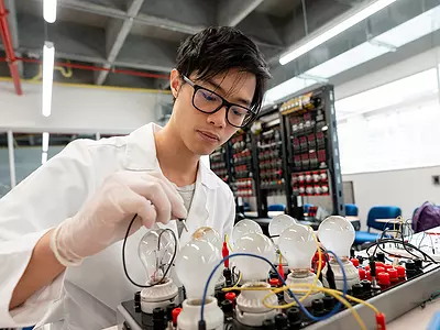 A high school student works in an electronics lab.