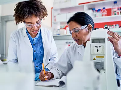 Two women of color working in a lab
