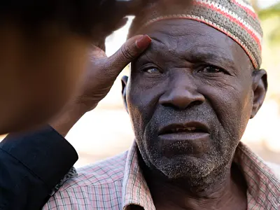 Photo of a senior man getting his eyes examined for diseases
