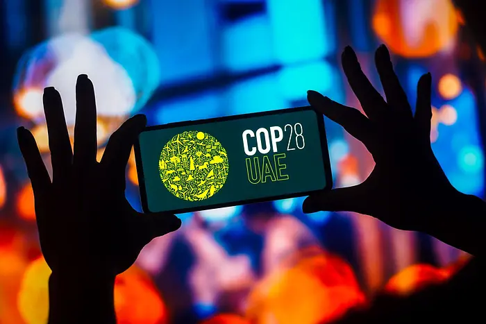 Smart phone with COP28 logo on screen
