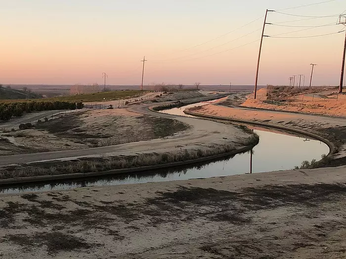 An irrigation canal brings water to the farmlands of California's Central Valley.