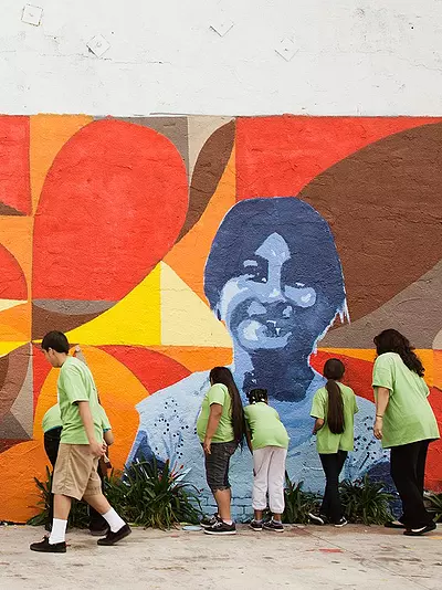 Group painting a bright mural