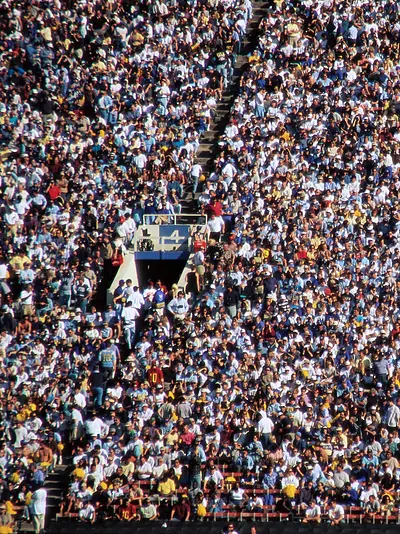A large, tightly packed crowd of spectators at a stadium