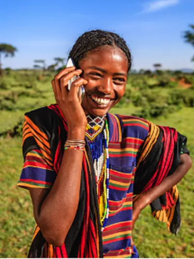 Women standing in a field talking on the phone