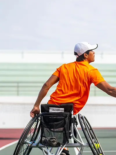 Man in wheelchair playing tennis