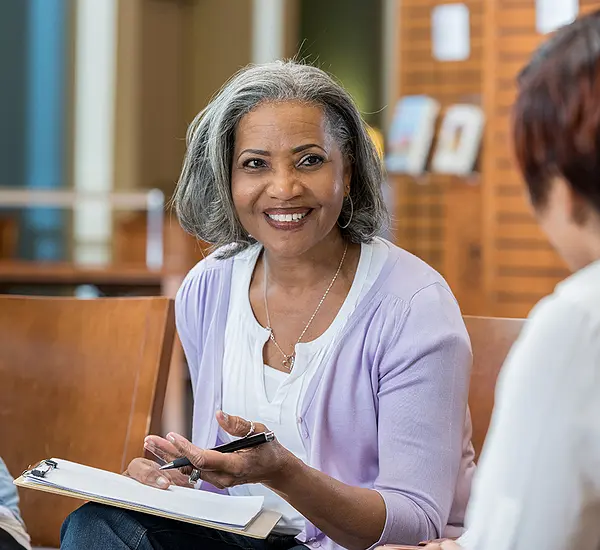 A Black female professor leads a book discussion.
