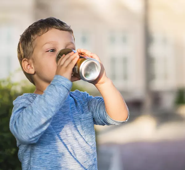 child drinking soda