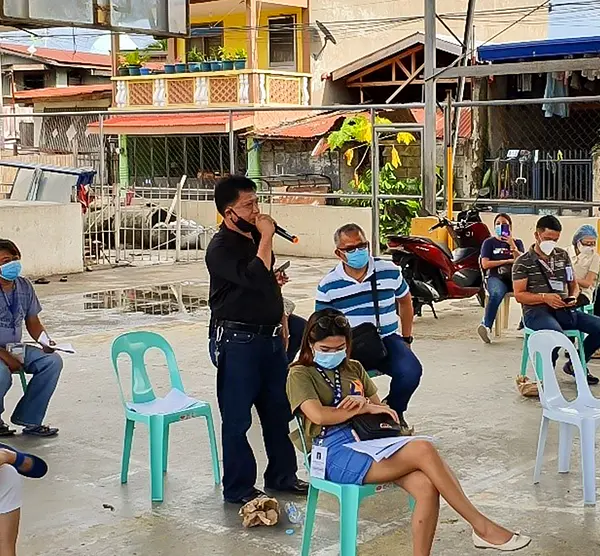 An outdoor training session for neighborhood-based emergency health workers during the COVID-19 pandemic in the Philippines.