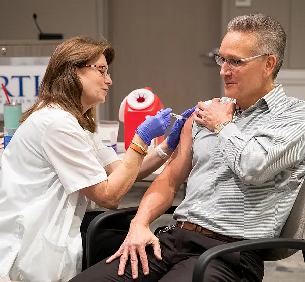 An RTI employee gets vaccinated during a flu shot clinic.
