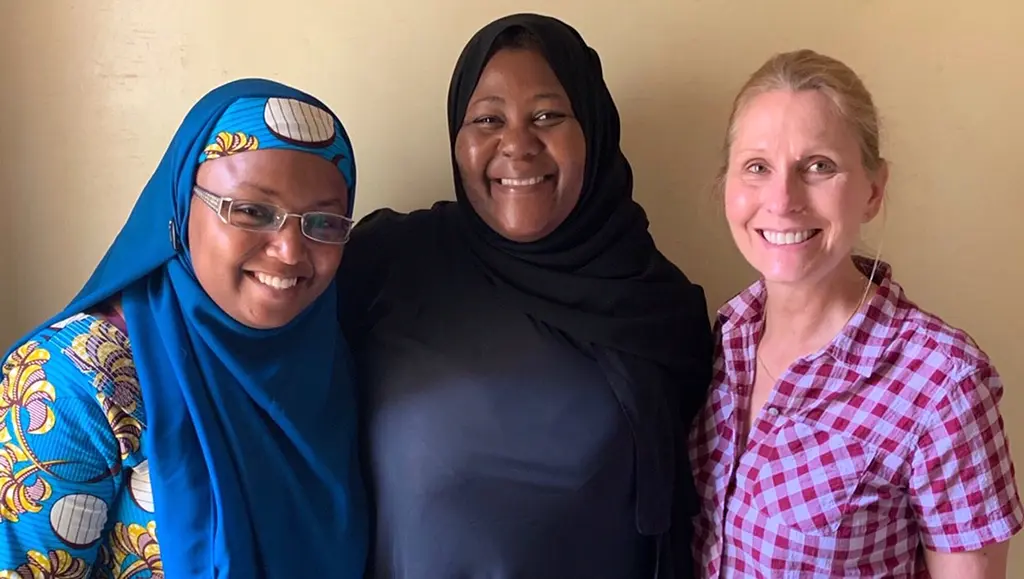 RTI resilience expert Tracy Mitchell meets with two small business managers in Niger in 2019