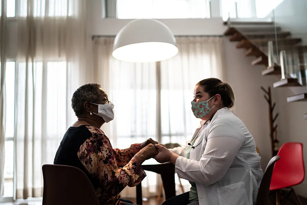 A home care nurse works with a senior patient.