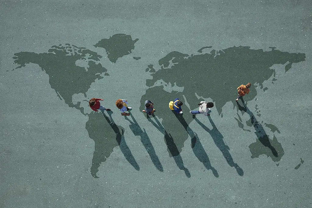 Overhead image of a group of people walking across a painted world map on the ground.