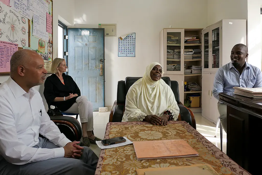 Head teacher and principal Saada Mwalimu discusses programs at the Urafiki Primary School in Zanzibar with RTI visitors, June 2023