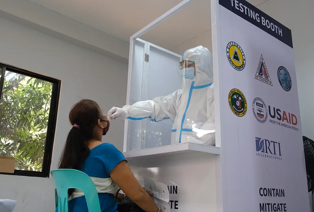 Vilma Cabral gets tested for COVID-19 at a USAID-supported community-based testing center in the Philippines.