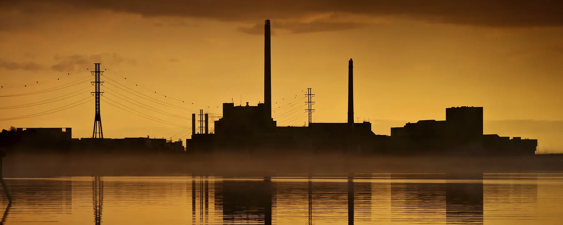 An electric power plant with a sunset background