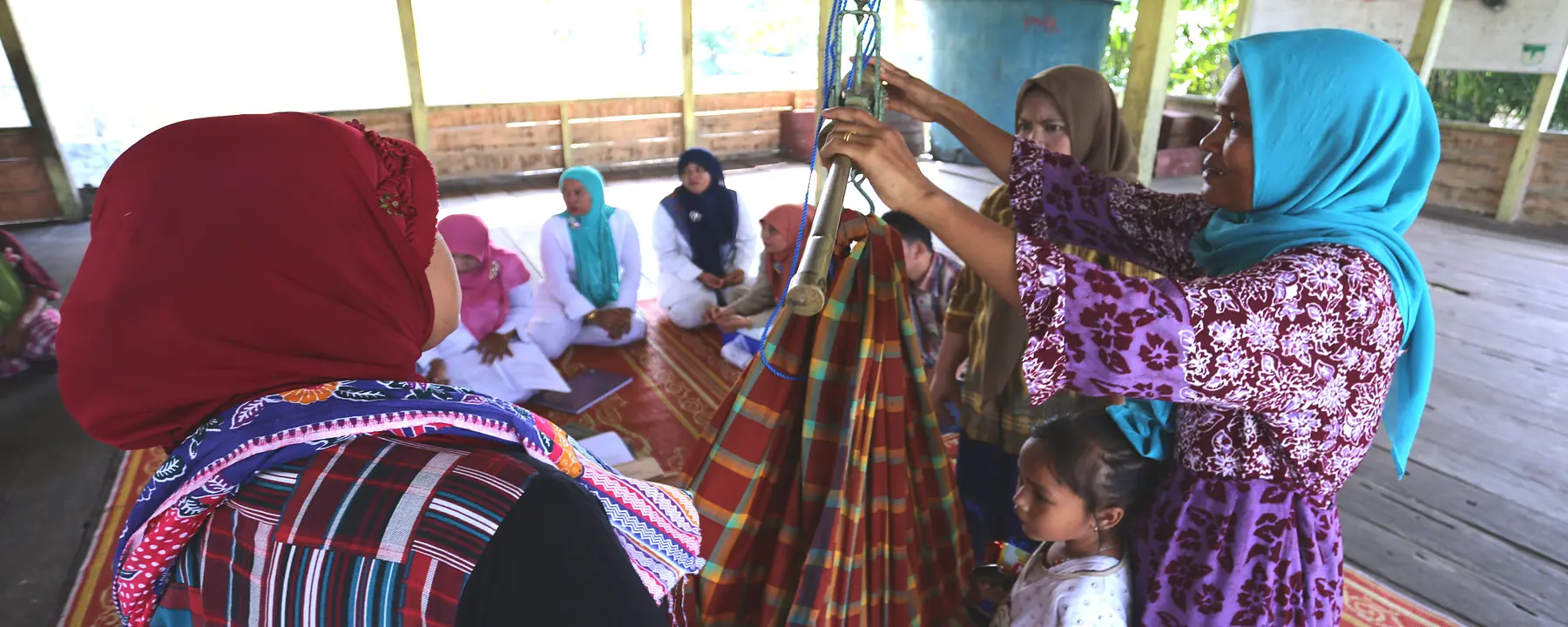 Health workers in Aceh Singkil weigh babies