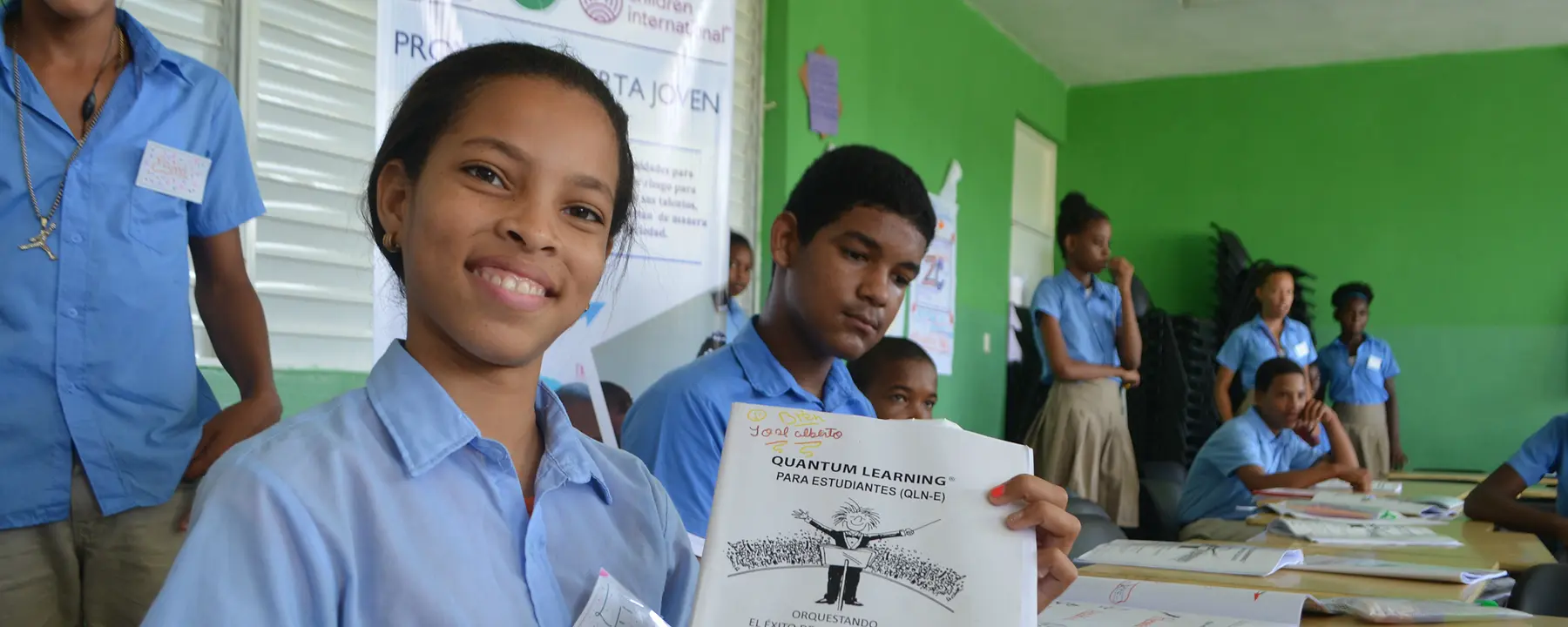 A teenage girl shows her work in an Alerta Joven academic program in the Dominican Republic.