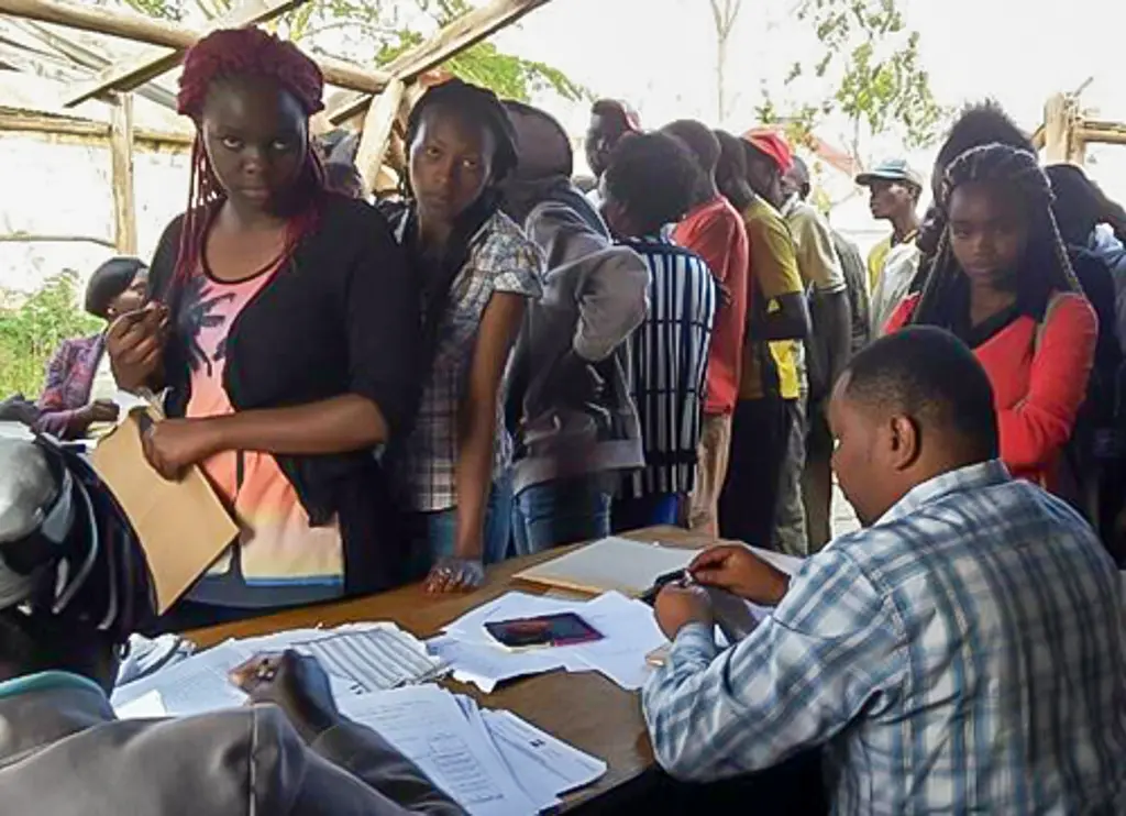 Young adults in Kenya wait in a line to register for national ID cards.