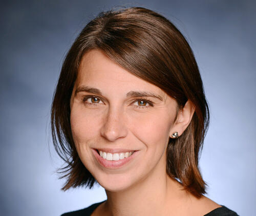 Headshot of Heather Danysh smiling against a blue background
