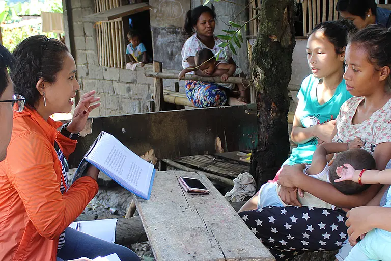Workers from the ReachHealth program interview a group of teenage mothers in the Philippines.