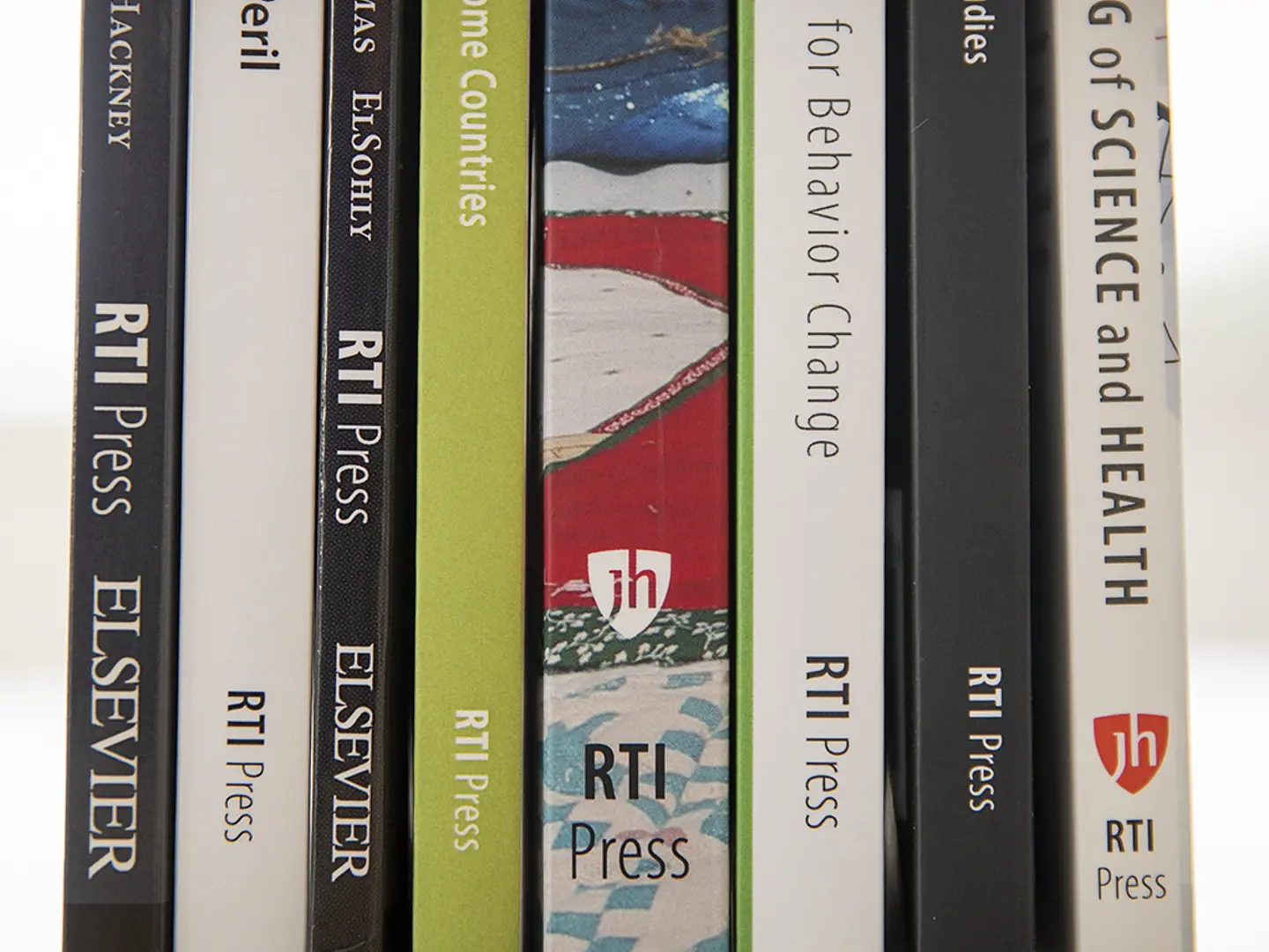 A selection of RTI Press books, shown on a shelf.