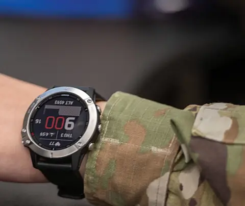 Close-up of wrist of military personnel wearing health-tracking watch