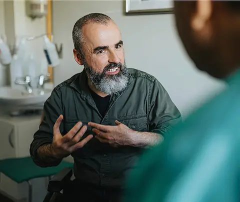 Man speaks with health care professional