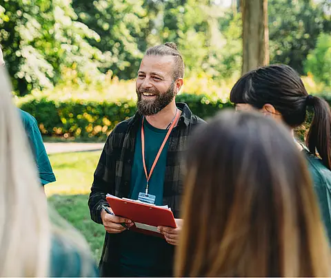 Male volunteer holds clipboard