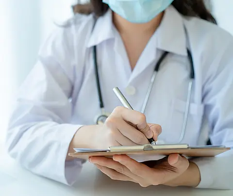 Stock photo of doctor holding clipboard