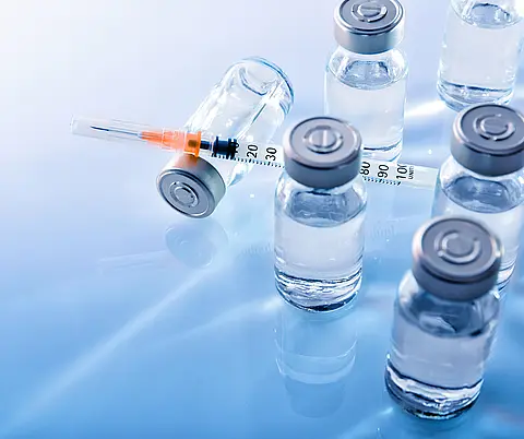 A set of insulin vials and syringes for diabetes treatment.