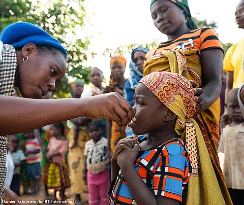 Volunteers treat children for trachoma during a treatment campaign in Mozambique.