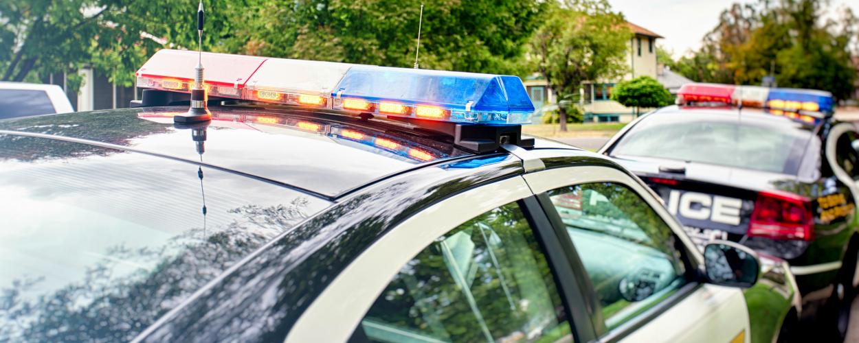 Police cars on a city street in the daytime
