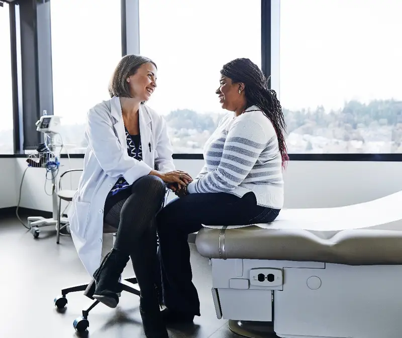 Doctor talking with a patient in an exam room